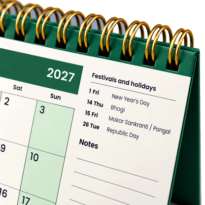 2027 desk calendar in Bottle Green, close-up of the gold wire-o binding, punched holes and festival list