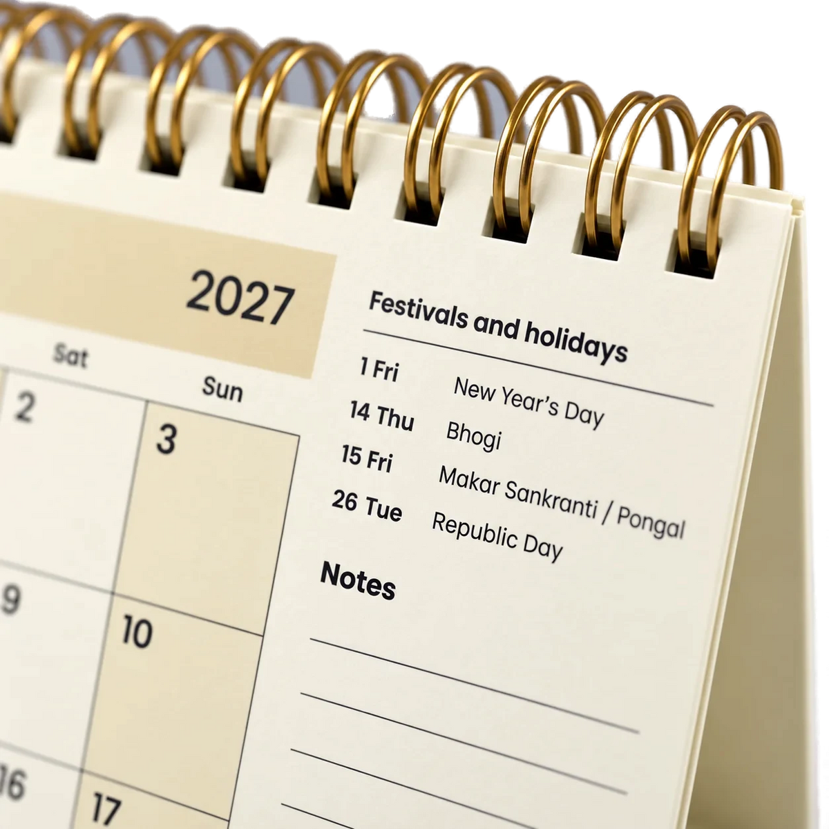 2027 desk calendar in Cream, close-up of the gold wire-o binding, punched holes and festival list
