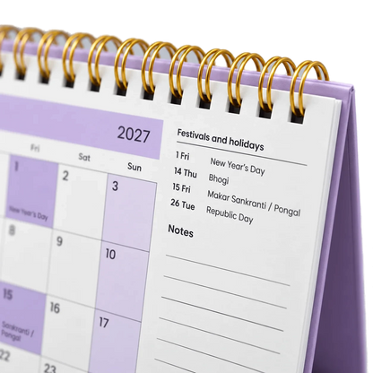 2027 desk calendar in Lavender, close-up of the gold wire-o binding, punched holes and festival list
