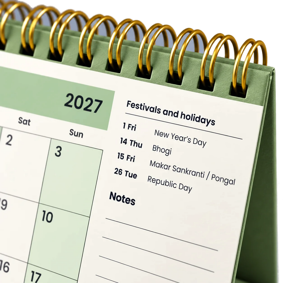 2027 desk calendar in Sage Green, close-up of the gold wire-o binding, punched holes and festival list